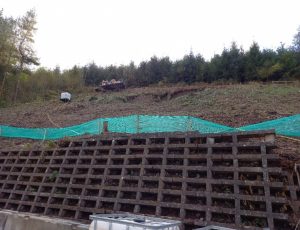 P60 slope climbing drilling rig operating above the retaining wall adjacent to the A40 Brecon Bypass 